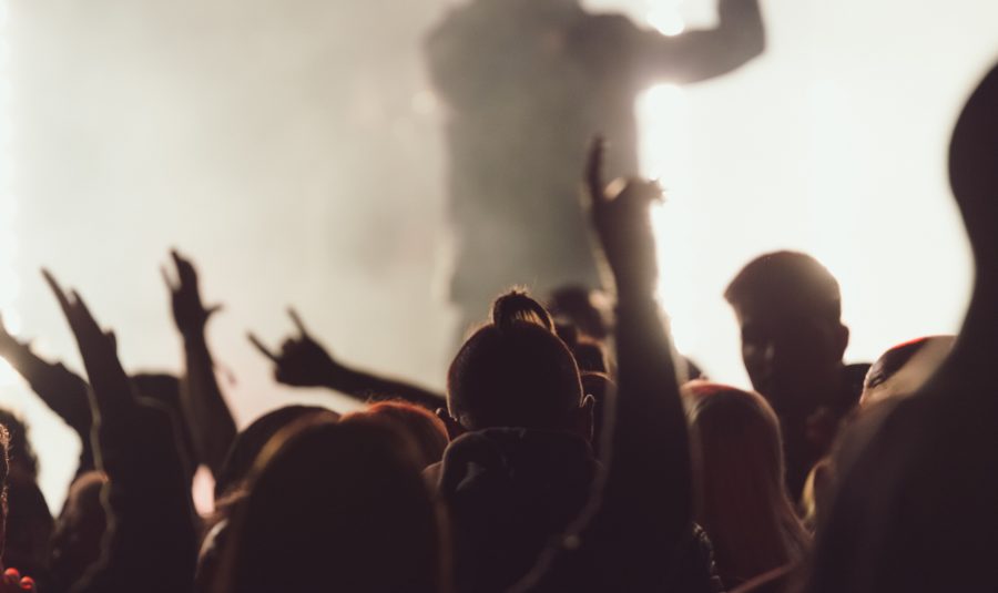 dancing-concert-while-singer-is-performing-surrounded-by-lights
